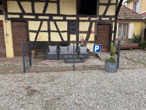 a fence with chairs in front of a house at Studio 3 étoiles avec grand JACUZZI PRIVÉ in Horbourg +1 photo