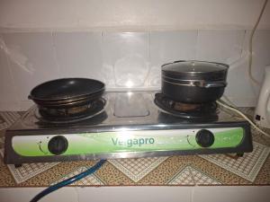 a stove with two pots on top of it at Bright Homes in Eldoret