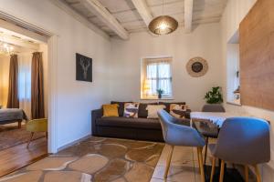 a living room with a couch and a table at Őri Art Inn in Őriszentpéter