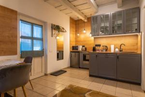 a kitchen with stainless steel appliances and a window at Őri Art Inn in Őriszentpéter
