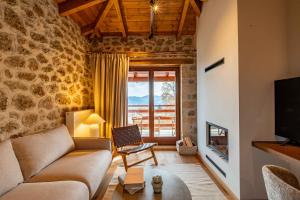 a living room with a couch and a fireplace at Levanta Guesthouse in Synikia Mesi Trikalon