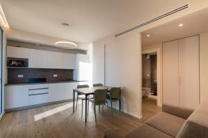 a kitchen and dining room with a table and chairs at VillaPignone in Genoa