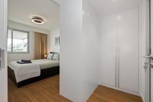 a bedroom with a bed and a sliding glass door at Oceanfront Bliss - Atlantico residences in Câmara de Lobos +17 photos