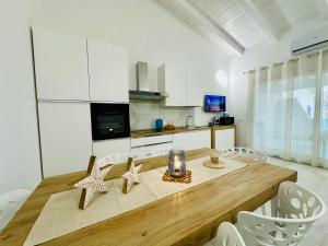 a kitchen with a wooden table with stars on it at AZZURRO meraviglioso attico a pochi passi dal mare in Valledoria