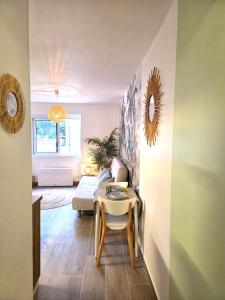 a living room with a table and a couch at CARANCO - Port et Plage à Pied, AC, WiFi, Parking Inclus in Cassis