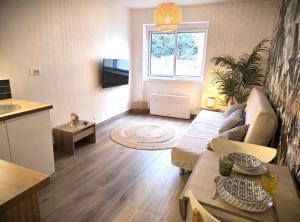a living room with a couch and a table at CARANCO - Port et Plage à Pied, AC, WiFi, Parking Inclus in Cassis