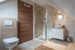 a bathroom with a toilet and a sink and a shower at Őri Art Inn in Őriszentpéter +76 photos
