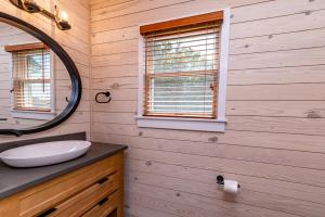 a bathroom with a sink and a mirror at Sunset Royale - Duck, Sanderling, Soundfront, Sound View, Beach 350 Yds, Community Pool, Kayak, YR Flex Stays in Duck +40 photos