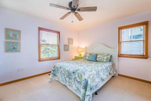a bedroom with a bed and a ceiling fan at Sunset Royale - Duck, Sanderling, Soundfront, Sound View, Beach 350 Yds, Community Pool, Kayak, YR Flex Stays in Duck