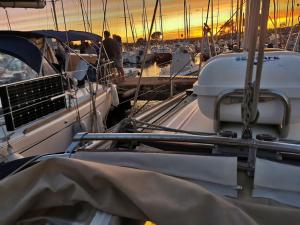 a group of boats docked in a harbor at sunset at Voilier in Propriano
