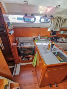 a kitchen with a sink and a stove at Voilier in Propriano
