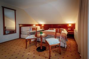 a bedroom with a bed and a table and chairs at Kala B&B in Kranjska Gora