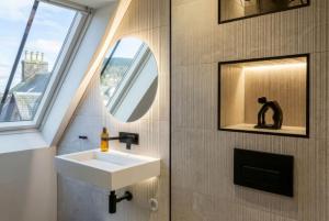 a bathroom with a sink and a mirror at Arran Shores Luxury Shorefront Penthouse Suite 13 in Lamlash
