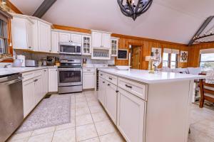 a kitchen with white cabinets and white appliances at Duck Diamond - Sanderling, Ocean View, 95 Yds to Beach, Hot Tub, Sauna, Community Pool in Duck
