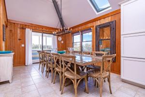 a dining room with a table and chairs at Duck Diamond - Sanderling, Ocean View, 95 Yds to Beach, Hot Tub, Sauna, Community Pool in Duck
