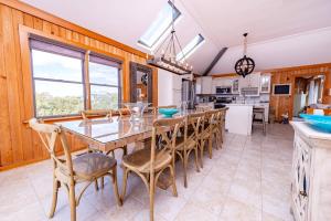 a kitchen and dining room with a table and chairs at Duck Diamond - Sanderling, Ocean View, 95 Yds to Beach, Hot Tub, Sauna, Community Pool in Duck +55 photos