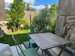 a wooden table and chairs on a patio at Quinta da Lembrança in Arcos de Valdevez