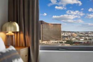 a view of a city from a hotel room window at Hyatus Designer Residences Somerville in Somerville +48 photos