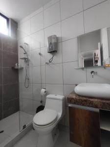 a bathroom with a toilet and a shower and a sink at Hospedaje Bry Ker in Pichanaki +13 photos