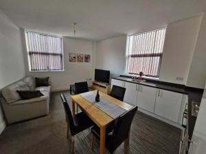 a living room with a table and a couch at The Cossy Nook in Bolton