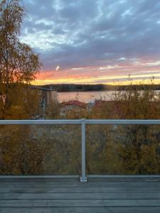 a view of a sunset from a balcony at Aurora views from 2 br apartment by lake in Yellowknife