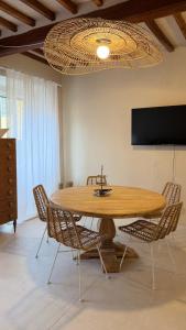 a dining room with a wooden table and chairs at Porto 24 in Portoferraio