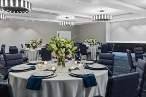 a conference room with tables and chairs and flowers at Courtyard by Marriott Oxford in Oxford +52 photos