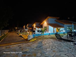 a house with a playground at night at Pousada Aroma de Café em Socorro-SP in Socorro