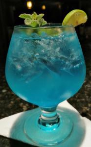 a blue drink in a glass on a table at Patate Heights in Hacienda El Carmen