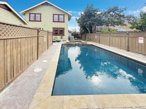 a swimming pool in front of a fence at F-60 Disney Dream Craftsman in Anaheim
