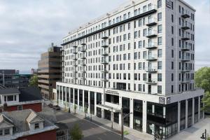 a large white building on a city street at AC Hotel by Marriott Burlington in Burlington