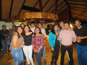a group of people standing on a dance floor at Patate Heights in Hacienda El Carmen