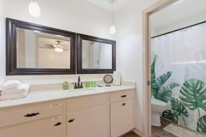 a bathroom with a sink and a toilet and a mirror at Rustic Retreat 5-BR Home with Backyard Oasis in Baton Rouge +24 photos