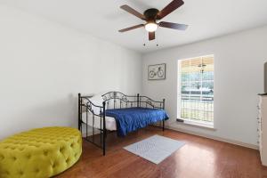 a bedroom with a bed and a ceiling fan at Rustic Retreat 5-BR Home with Backyard Oasis in Baton Rouge