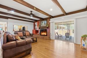 a living room with a couch and a fireplace at Rustic Retreat 5-BR Home with Backyard Oasis in Baton Rouge