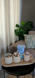 a coffee table with three bowls on top of a couch at HomeLand Place AL in Horta