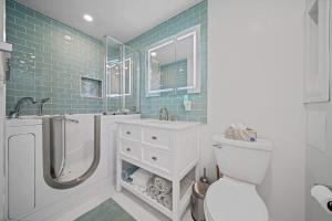 a bathroom with a toilet and a shower and a sink at Private Cottage on Annie in Coeur d'Alene