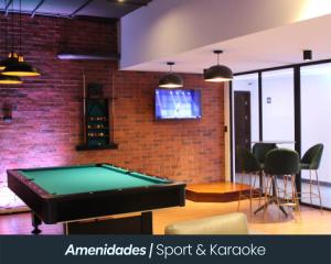 a pool table in a room with a brick wall at Eon 5 - Apartamento en edificio de lujo - Zona 10 de la Ciudad de Guatemala in Estación Pamplona +2 photos