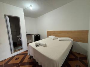 a bedroom with a large bed with a wooden headboard at Prédio AZUL in Itacaré