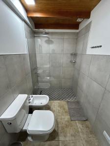 a bathroom with a toilet and a sink at Luminosa Patagónia in Lago Puelo +26 photos
