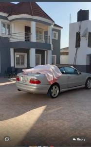 a car parked in a parking lot in front of a house at BUSUBALA Resident in Yundum