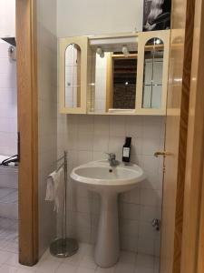 a bathroom with a sink and a mirror at Teatro Vecchio 11 in Bassano del Grappa +20 photos