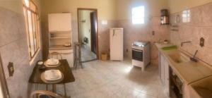 a small kitchen with a sink and a refrigerator at Mini Casa Tiradentes 2 in Tiradentes +46 photos