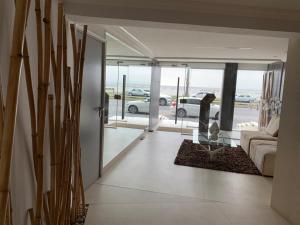 a living room with a couch and a view of a parking lot at Punta Carretas Vista al Mar in Montevideo