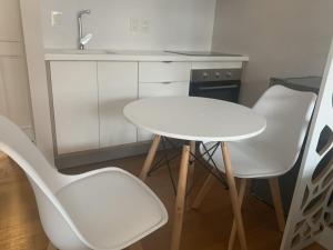 a white table and two chairs in a kitchen at Punta Carretas Vista al Mar in Montevideo