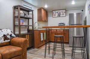 a kitchen with a bar with stools and a couch at Basement apartment in Twin Falls