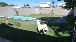 a yard with a chair and a swimming pool at La posadita sp in San Pedro