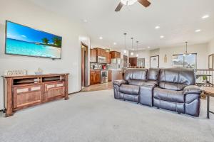 a living room with a couch and a tv on the wall at Bridges Bay Vacation Cabin 185 in Arnolds Park
