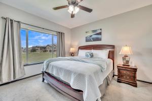 a bedroom with a bed and a window at Bridges Bay Vacation Cabin 185 in Arnolds Park +91 photos