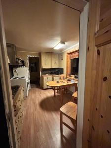 a kitchen with a table and a tableasteryasteryasteryasteryasteryasteryasteryastery at Old farm house & sauna in Stunes